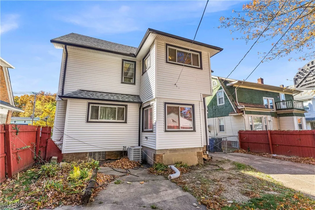 Back of property featuring a shingled roof