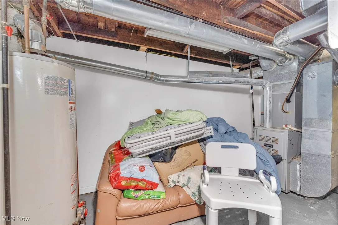 Unfinished basement with gas water heater and heating unit