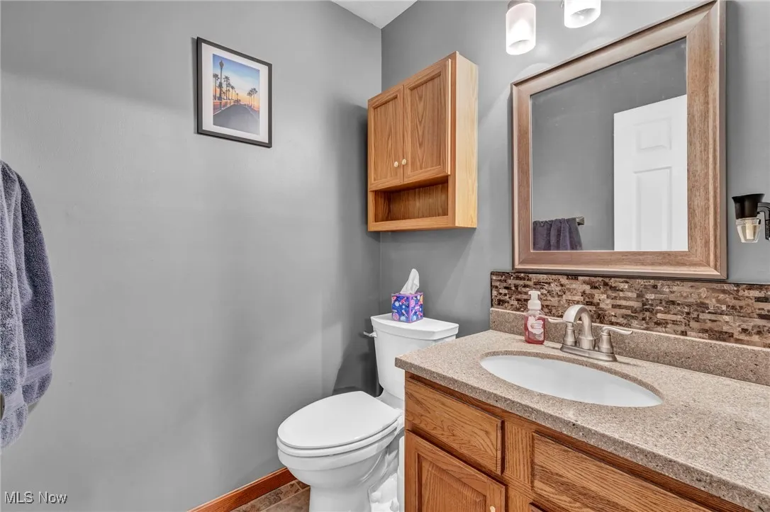 Bathroom featuring vanity and backsplash