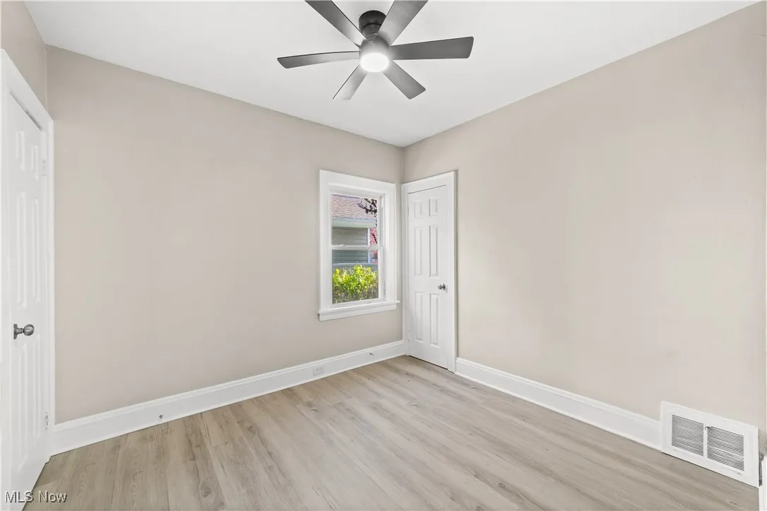 Spare room with light wood-type flooring and ceiling fan