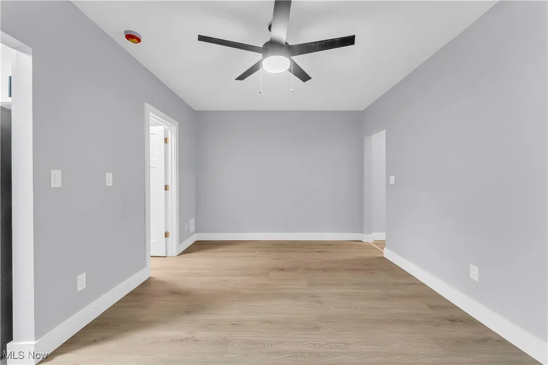 Spare room featuring light wood-style flooring and ceiling fan