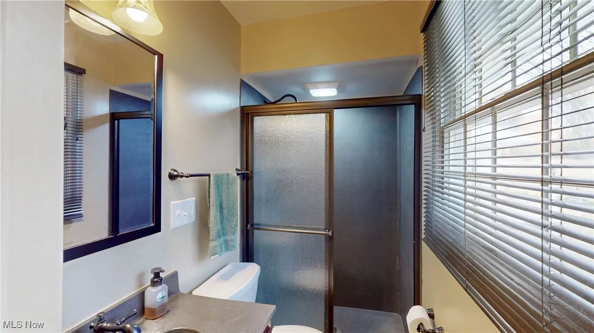 Bathroom featuring a stall shower and vanity