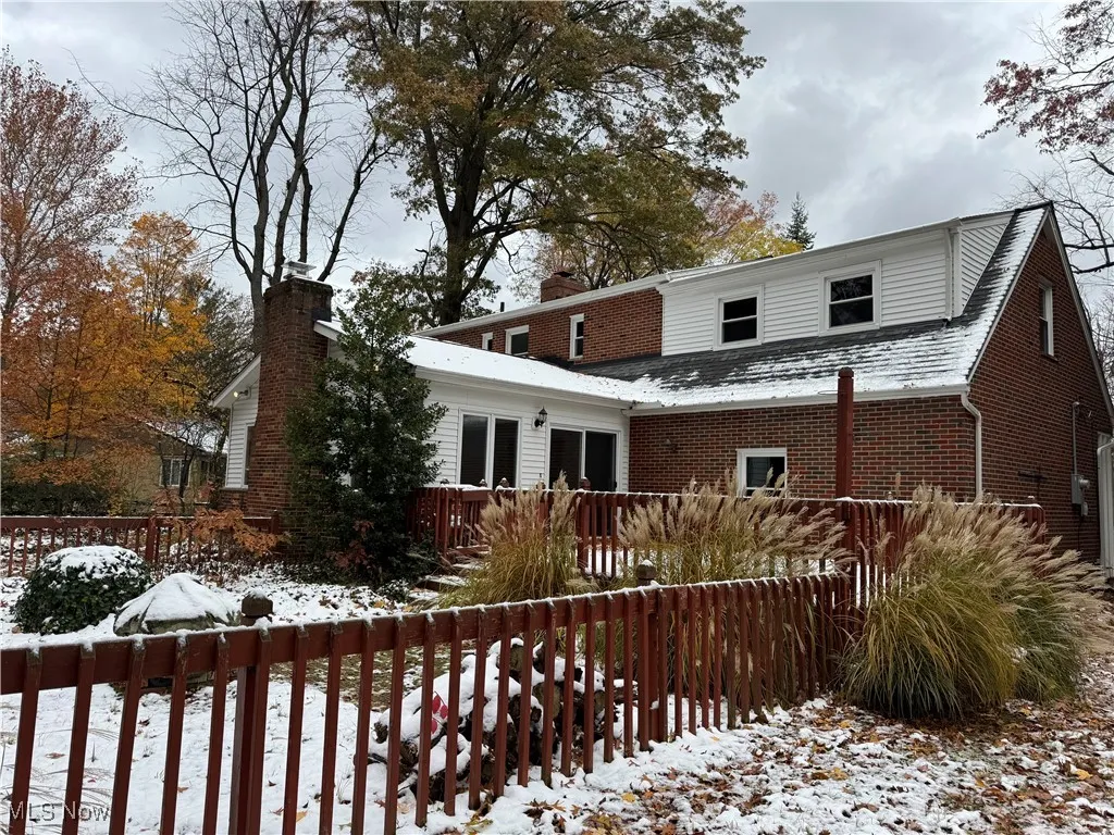 View of front of property with brick siding and a deck