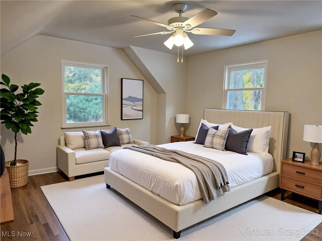 Bedroom with dark wood-style flooring and a ceiling fan