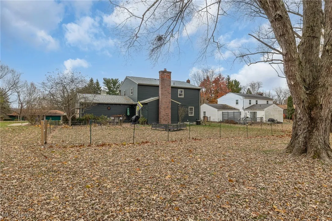 Back of house with a chimney