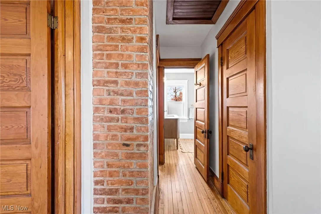 Hallway featuring light wood-style floors and baseboards
