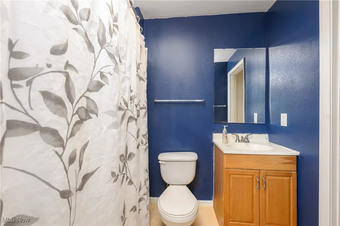 Bathroom with curtained shower and vanity
