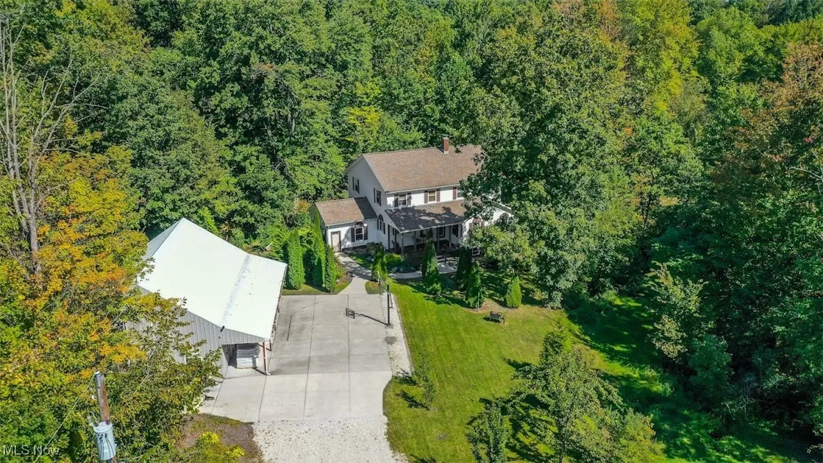 View of subject property with a forest