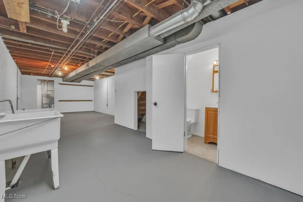 Below grade area featuring a sink and water heater