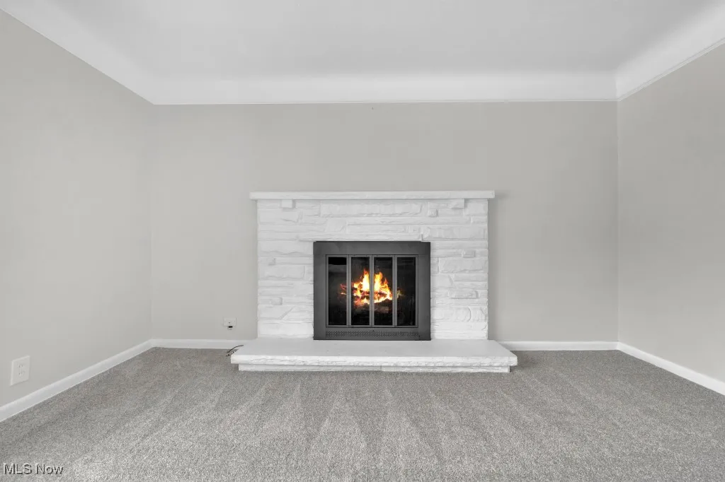 Detailed view of carpet floors and a stone fireplace