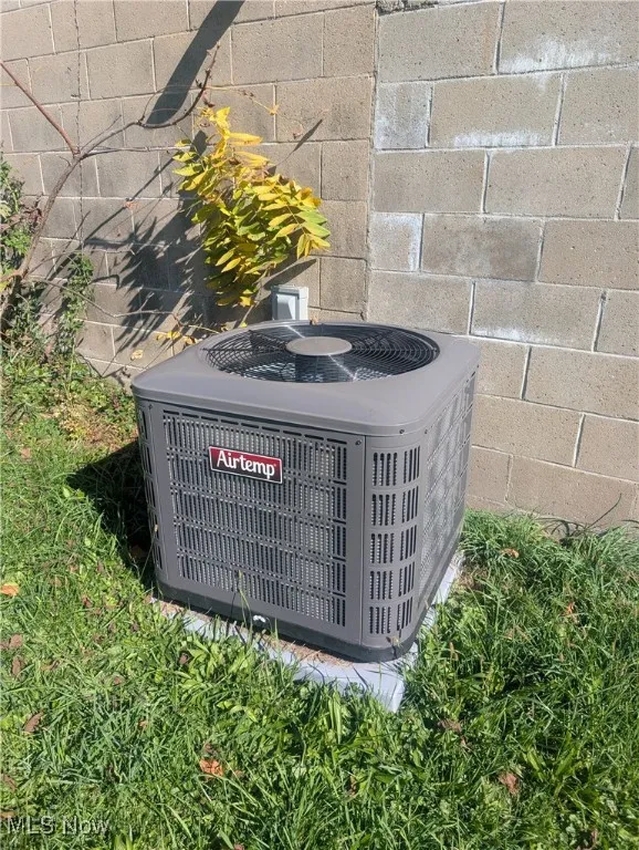 Exterior view of a cooling unit and concrete block siding