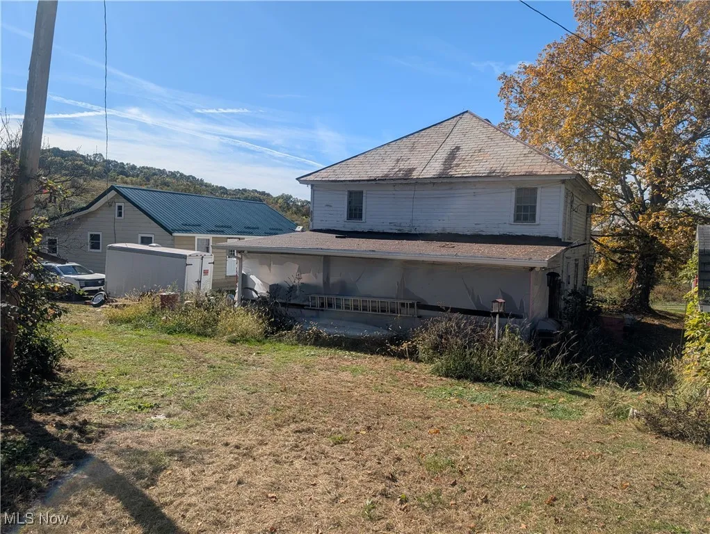 Back of property with a yard