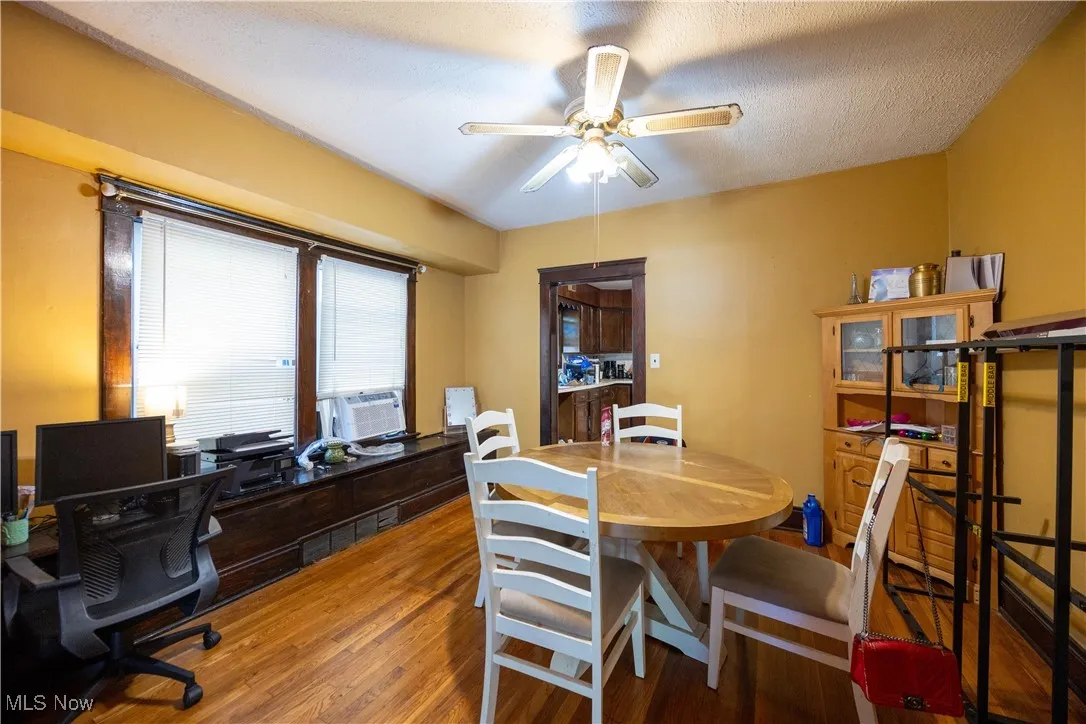 Lower unit dining room featuring wood finished floors, and a ceiling fan
