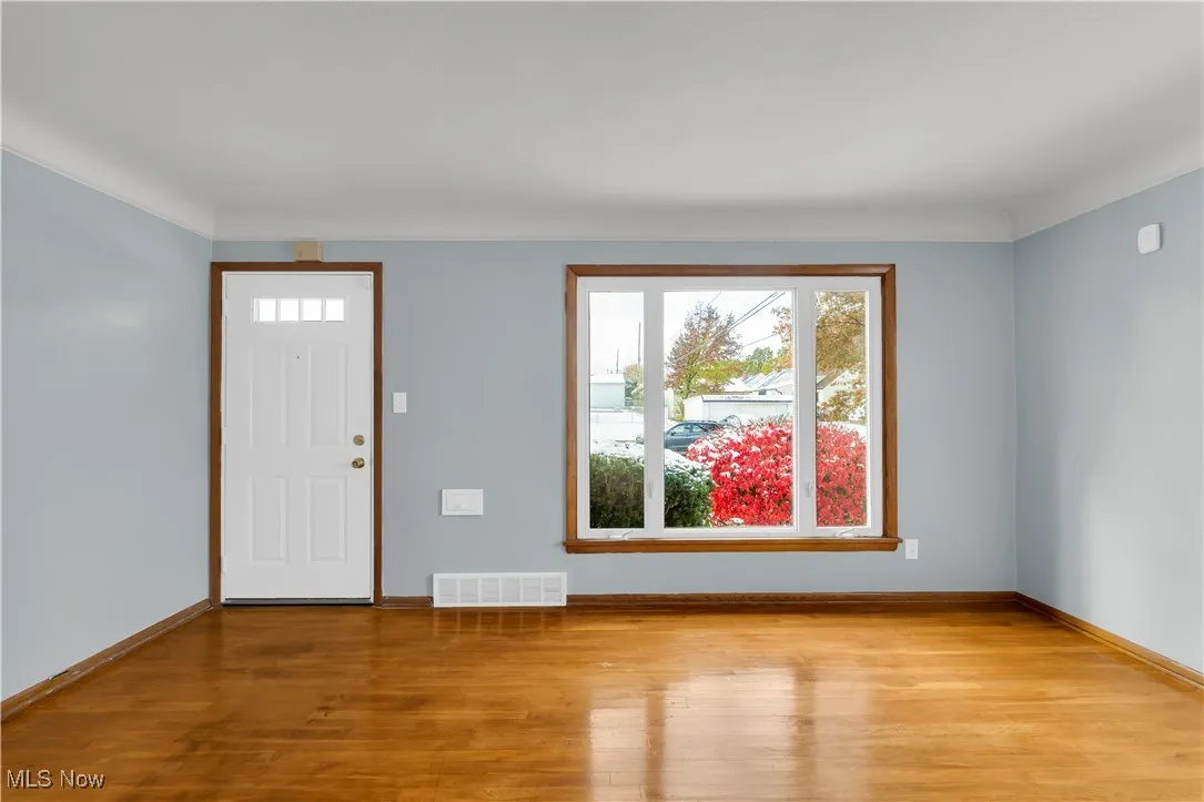 Entrance foyer with wood finished floors and baseboards