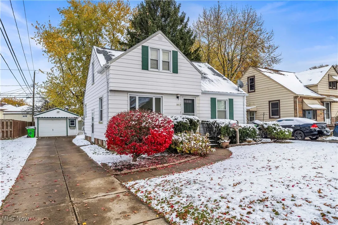 Bungalow featuring a garage, an outdoor structure, and driveway