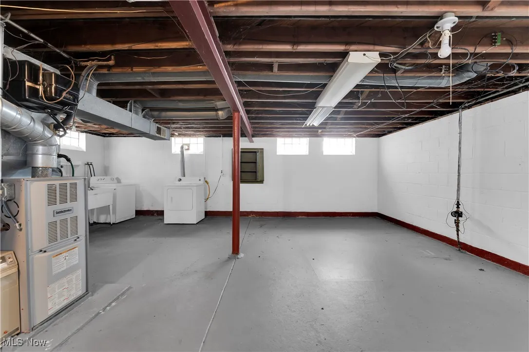 Below grade area featuring independent washer and dryer and heating unit