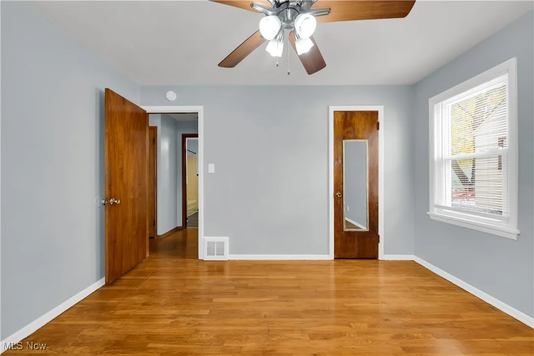 Empty room featuring light wood-style floors and a ceiling fan