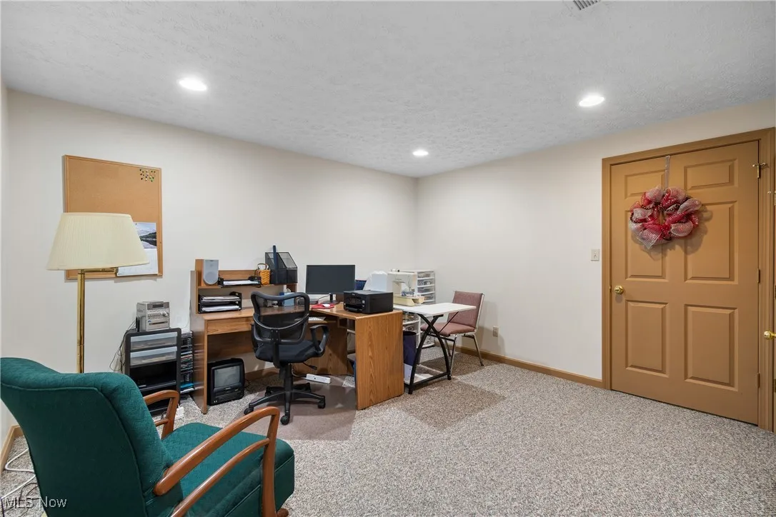 Office with light colored carpet, recessed lighting, and a textured ceiling
