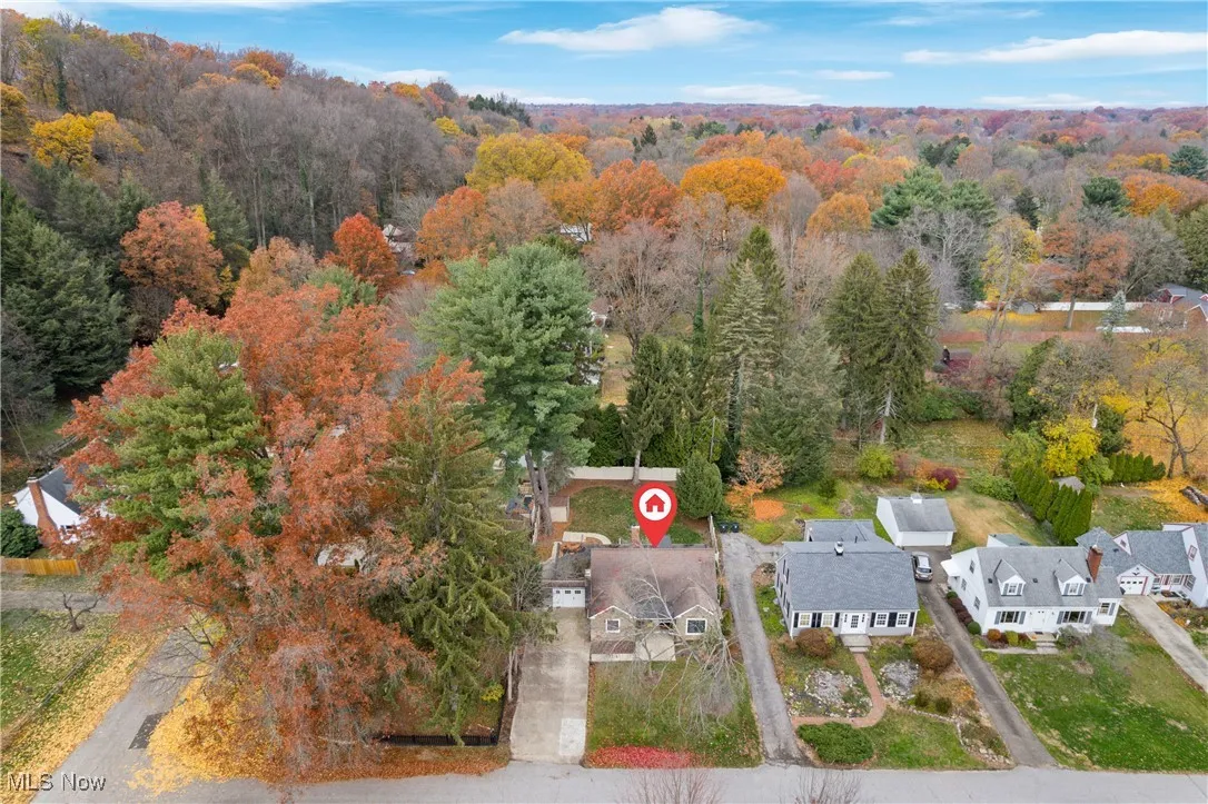 Aerial view of residential area featuring a heavily wooded area