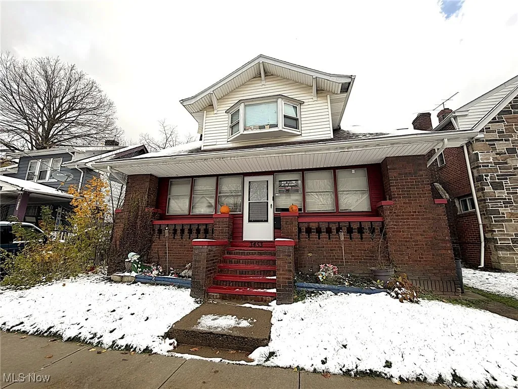 Bungalow with brick siding and covered porch
