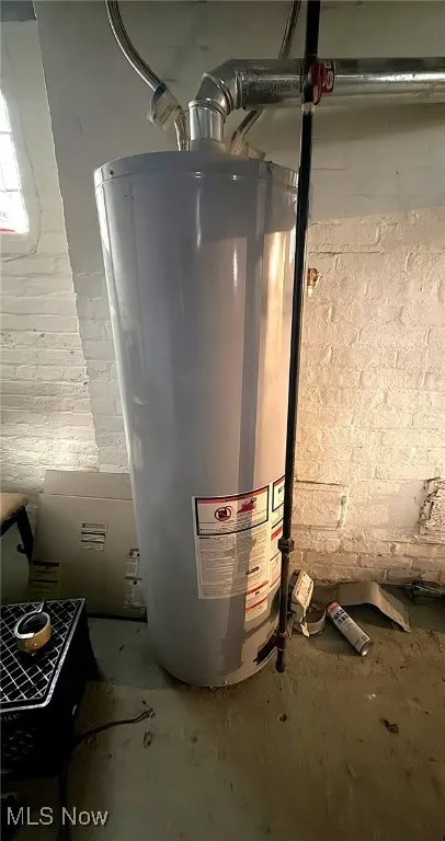 Utility room featuring gas water heater