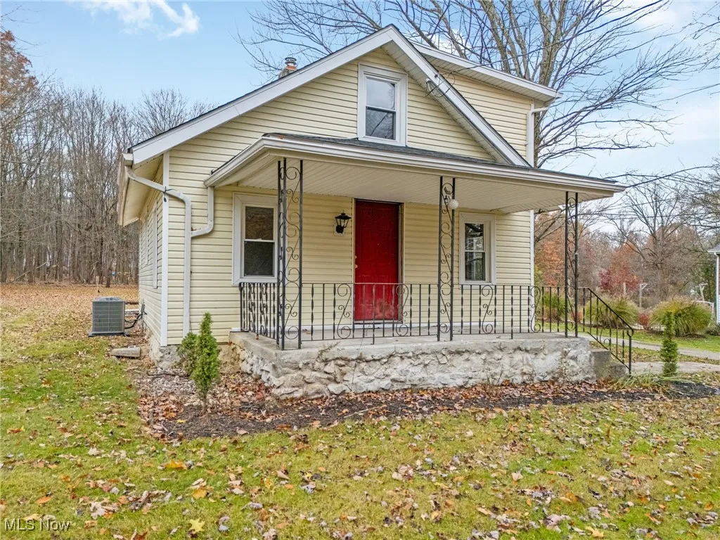 Bungalow with covered porch and a front lawn