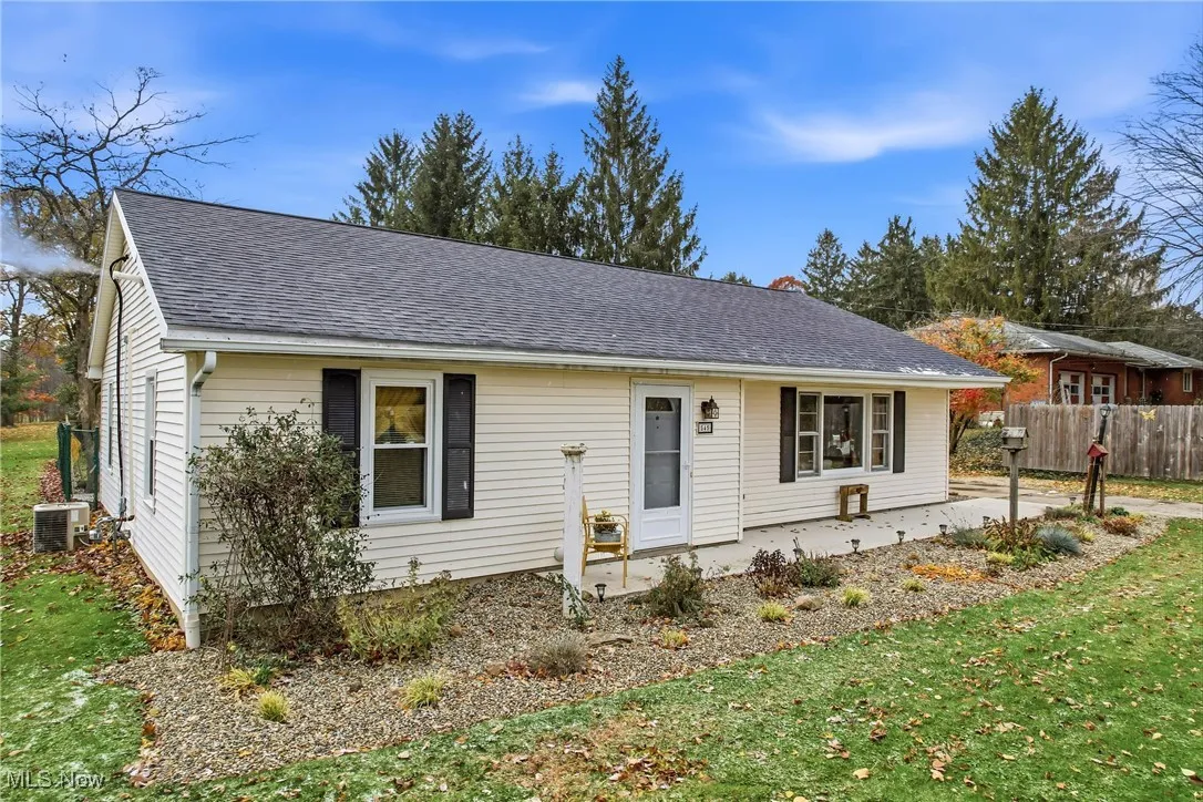 Front of home. Cement walk way in the front.  AC unit at the side