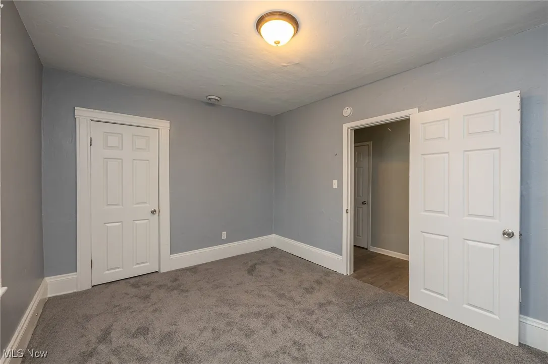 Unfurnished bedroom with carpet floors