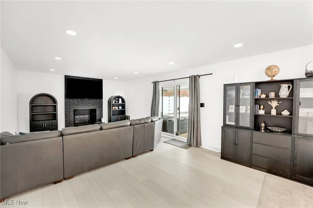 Unfurnished living room with a fireplace, recessed lighting, and light wood-style floors