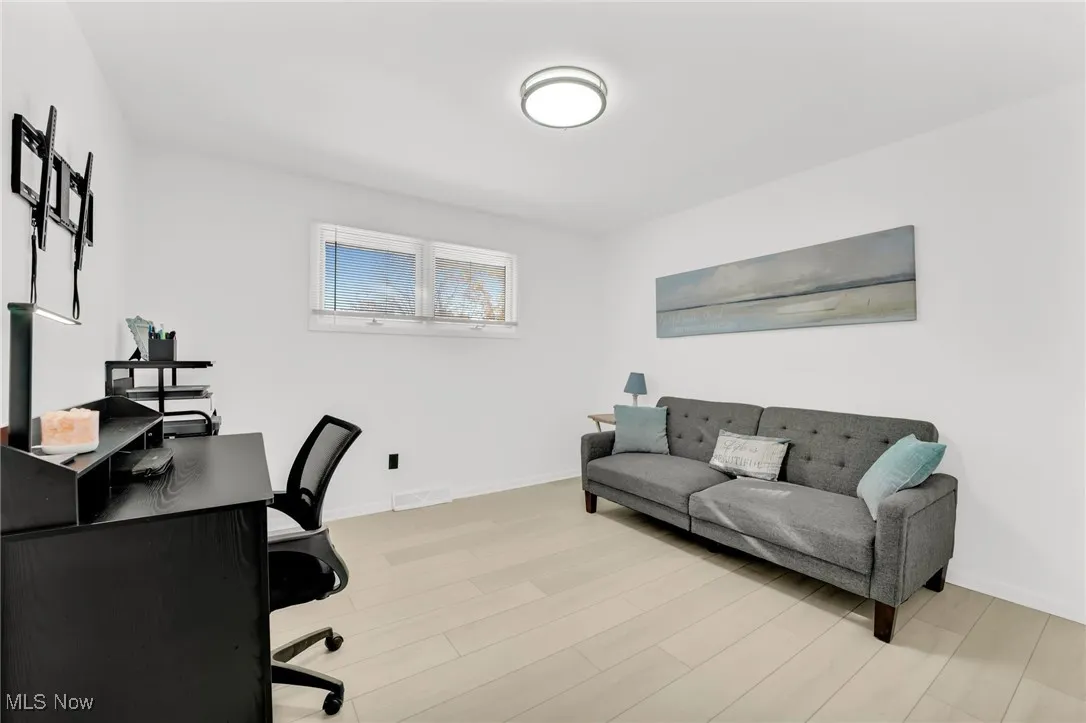 Upper Level Guest Bedroom 3 with light wood-style floors and baseboards