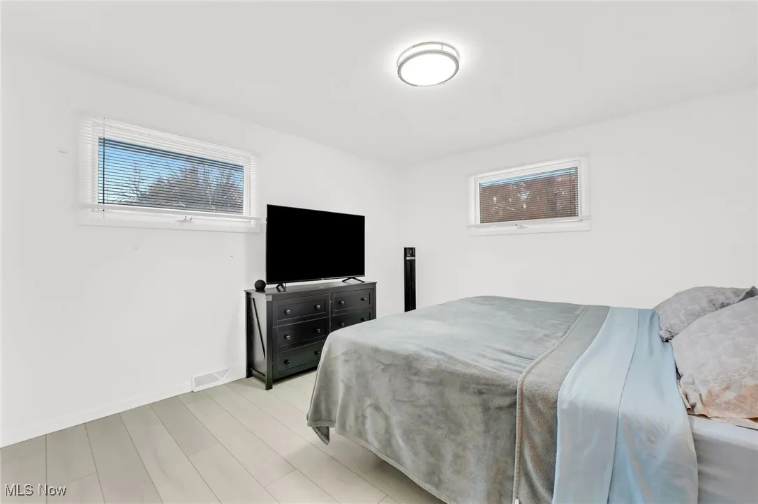 Upper Level Guest Bedroom 2 featuring light wood-style floors and baseboards
