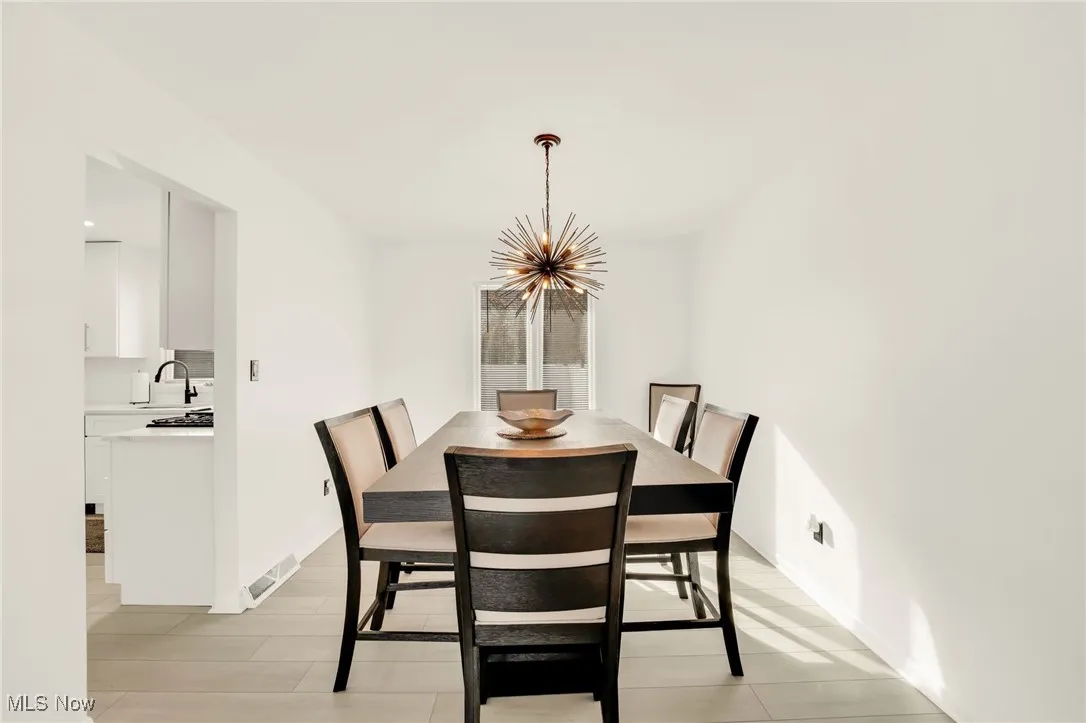 Dining space with a chandelier and light wood-style flooring