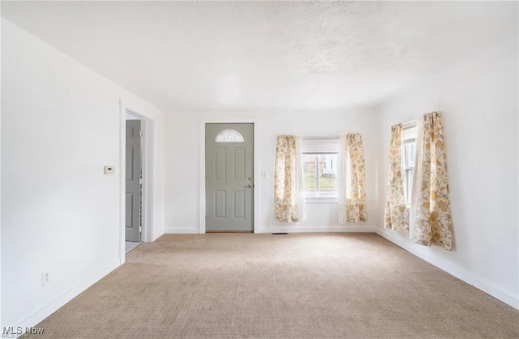 Entryway featuring carpet flooring and a textured ceiling