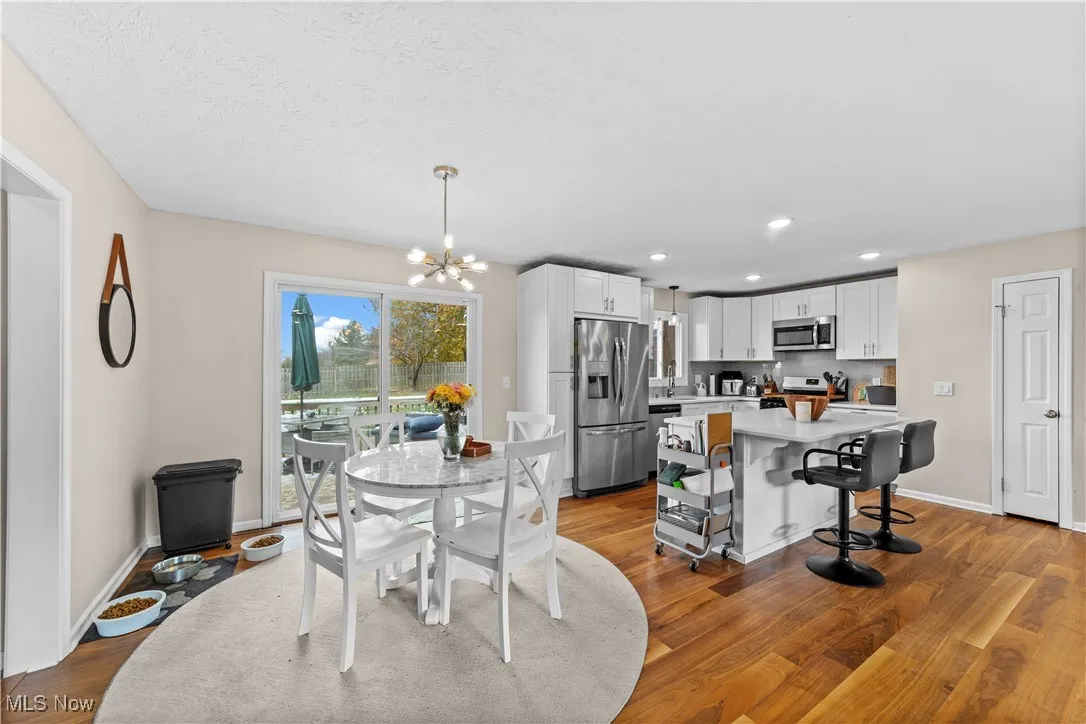 Dining room featuring light wood-style flooring, recessed lighting, and a chandelier