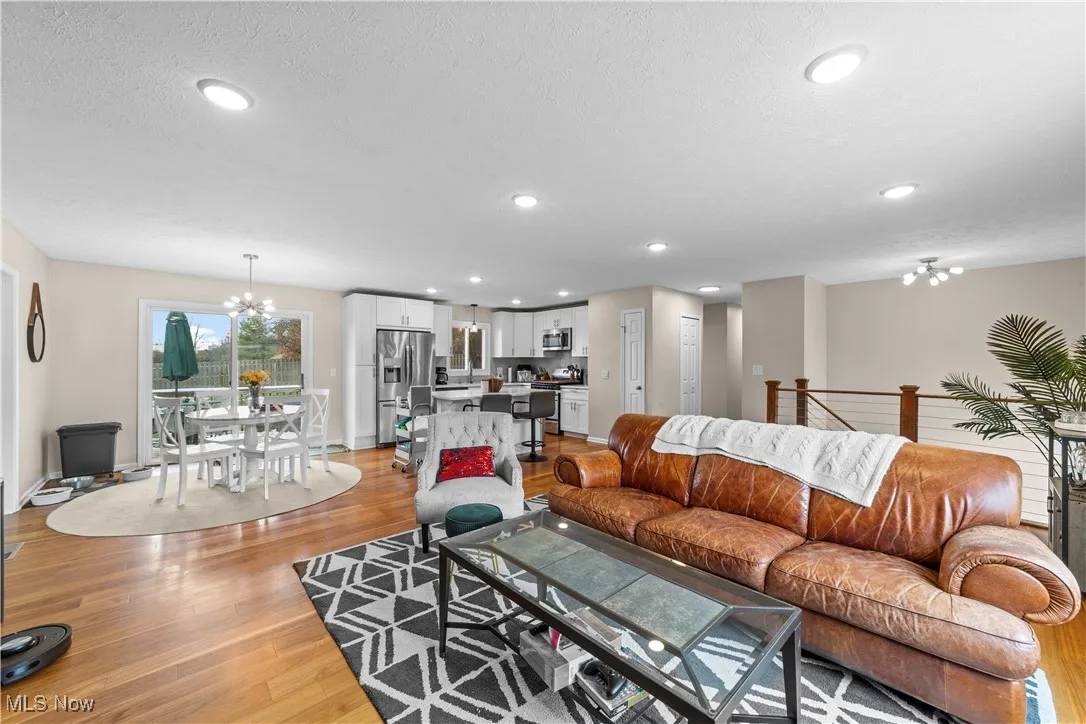 Living area featuring a chandelier, light wood finished floors, and recessed lighting
