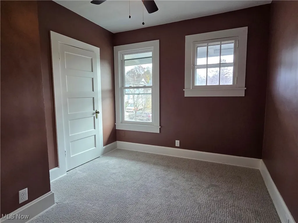 Spare room featuring carpet floors and a ceiling fan