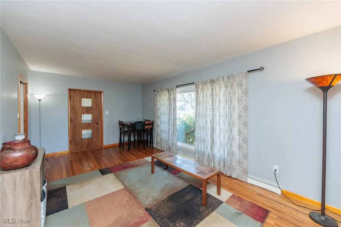 Living area featuring light wood-type flooring and baseboards