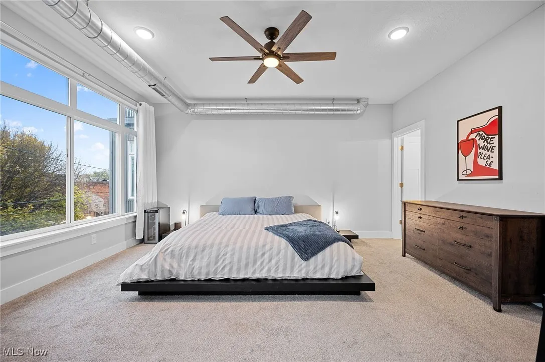 Bedroom featuring light carpet, ceiling fan, and recessed lighting