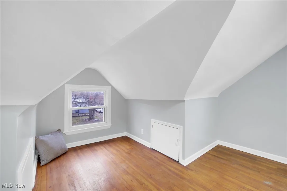 Bonus room with light wood finished floors and lofted ceiling