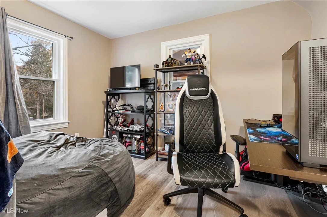 Bedroom featuring light wood finished floors and a heating unit