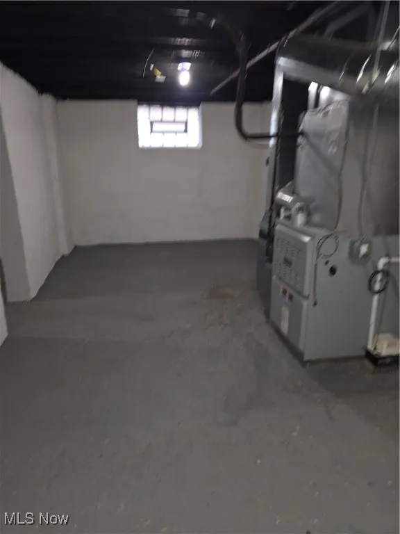 Basement featuring heating unit