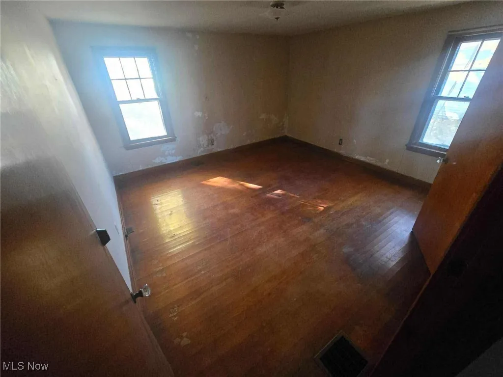 Empty room with dark wood finished floors