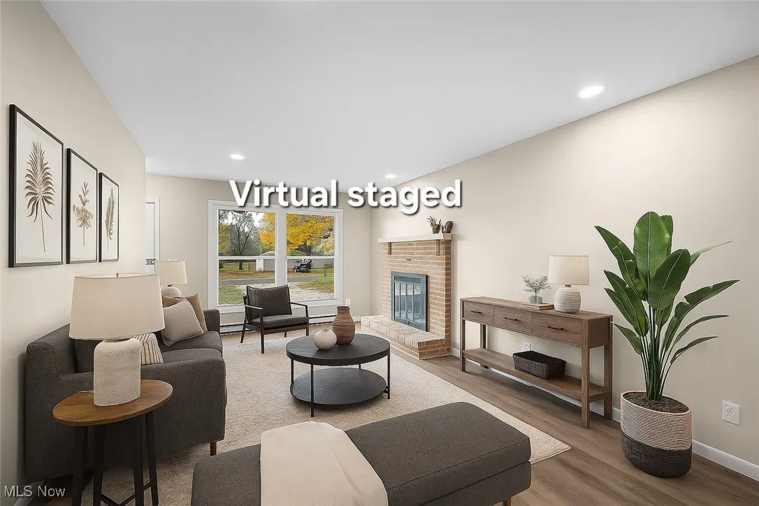 Living area featuring fireplace, wood floors, and recessed lighting