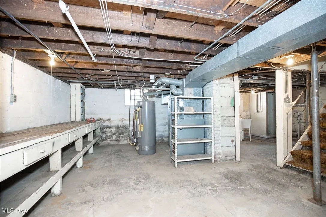Below grade area with water heater and stairs