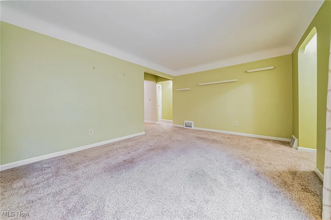 Empty room with carpet flooring and baseboards