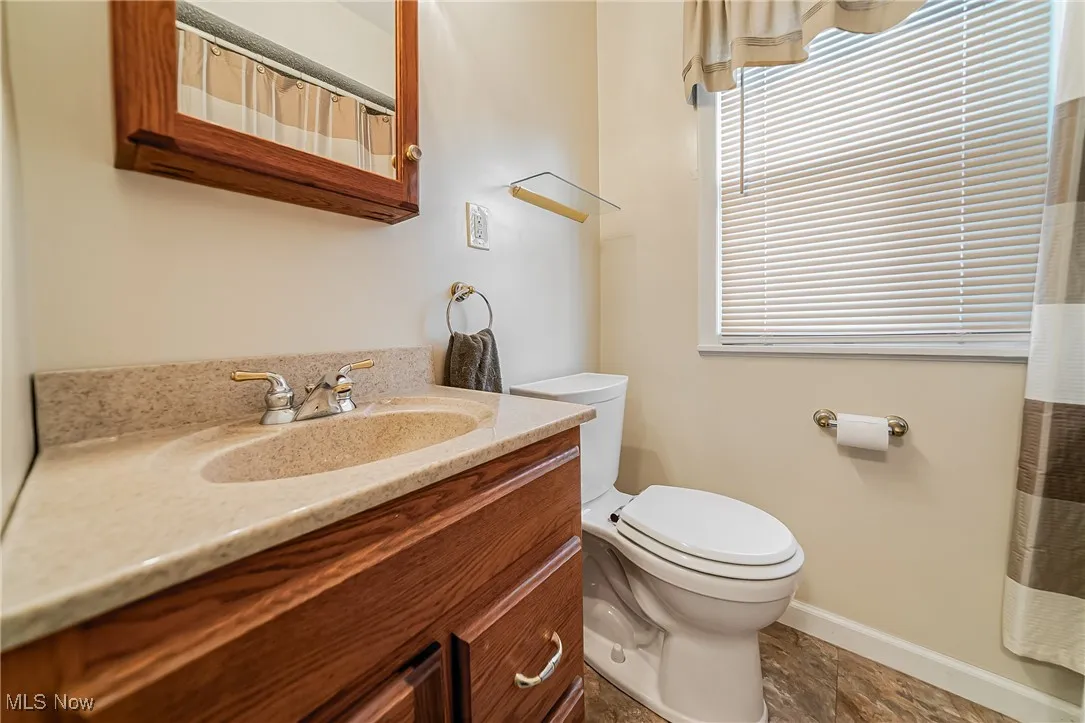 Bathroom featuring vanity and curtained shower