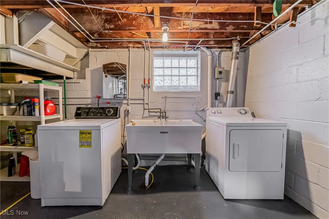 Laundry area with washing machine and dryer and concrete flooring