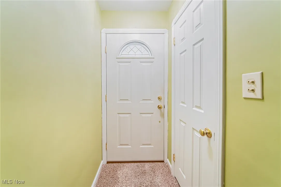 Doorway to outside featuring baseboards and​​‌​​​​‌​​‌‌​‌‌​​​‌‌​‌​‌​‌​​​‌​​ carpet