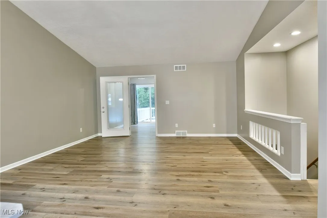 Spare room with light wood-style floors and recessed lighting