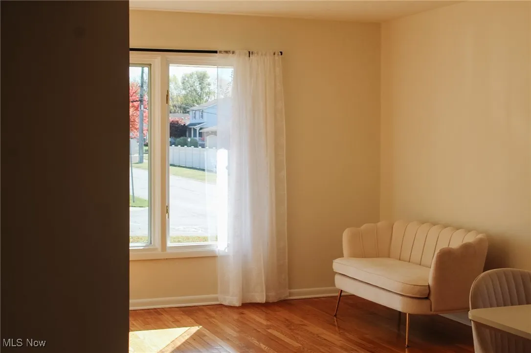 Living area featuring baseboards and light wood-type flooring